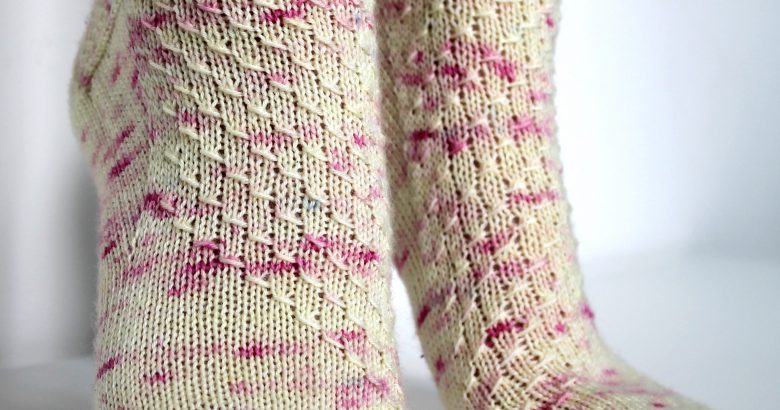 Speckled socks with a wide diagonal stripe with a textured pattern mirrored across each foot