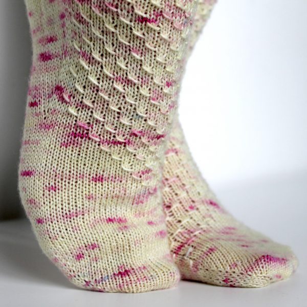 Speckled socks with a wide diagonal stripe with a textured pattern mirrored across each foot