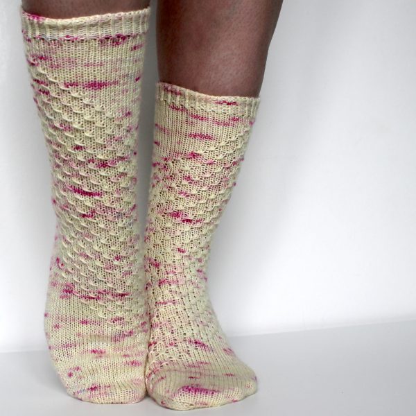 Speckled socks with a wide diagonal stripe with a textured pattern mirrored across each foot