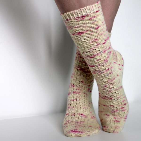 Speckled socks with a wide diagonal stripe with a textured pattern mirrored across each foot