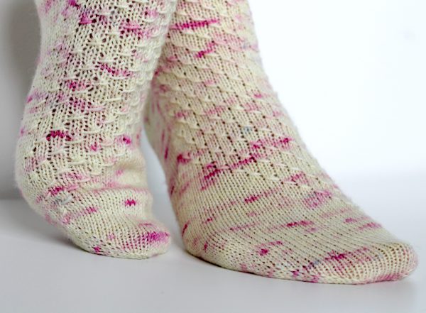 Speckled socks with a wide diagonal stripe with a textured pattern mirrored across each foot