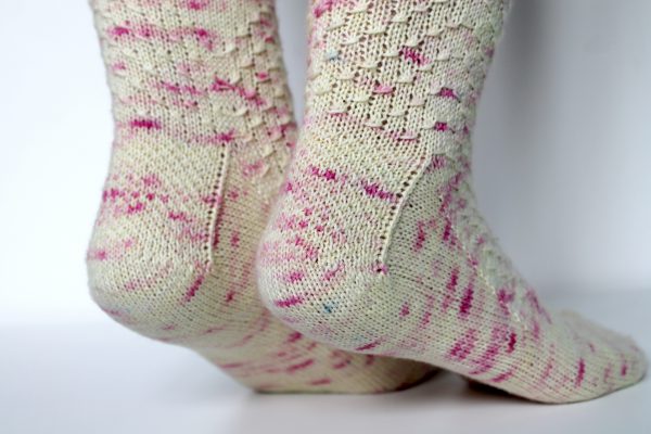 Speckled socks with a wide diagonal stripe with a textured pattern mirrored across each foot