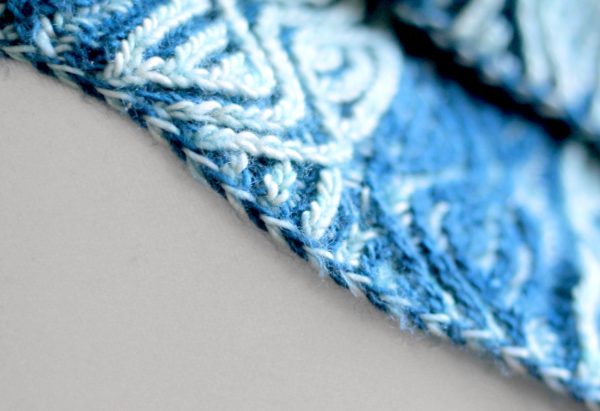 A close up on a brioche cowl showing the cast-on and bind-off