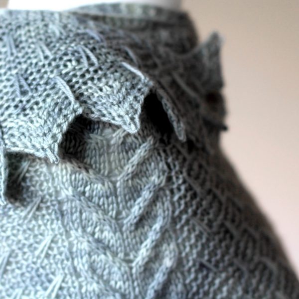 A close up on the chevron and slipped stitch edge and cabled spine of Fearthainn