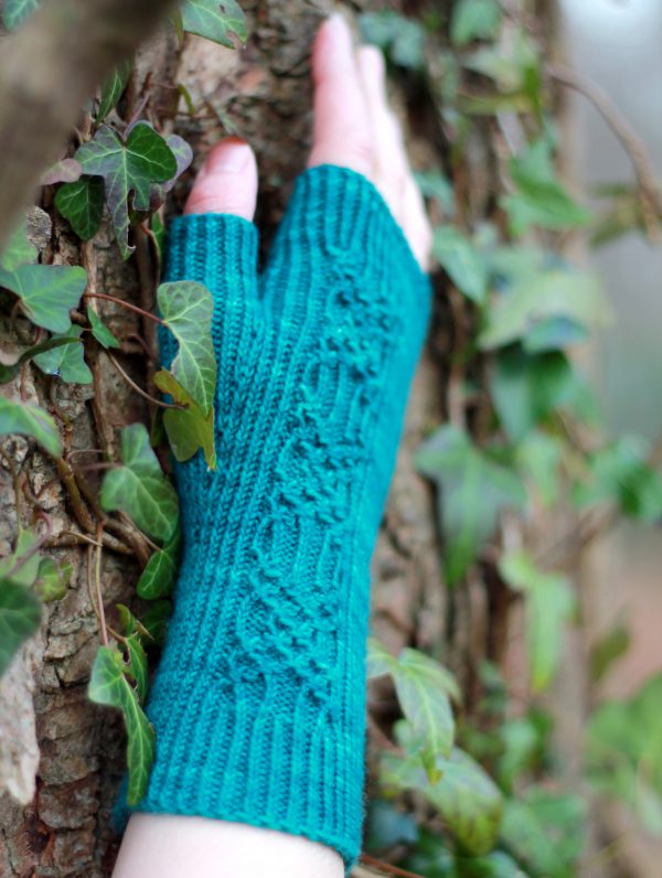 Twisted rib fingerless mitts with a smocked faux cable trellis patter asymmetrically on the back of the hand