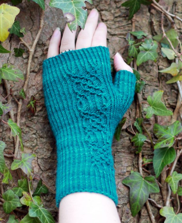 Twisted rib fingerless mitts with a smocked faux cable trellis patter asymmetrically on the back of the hand