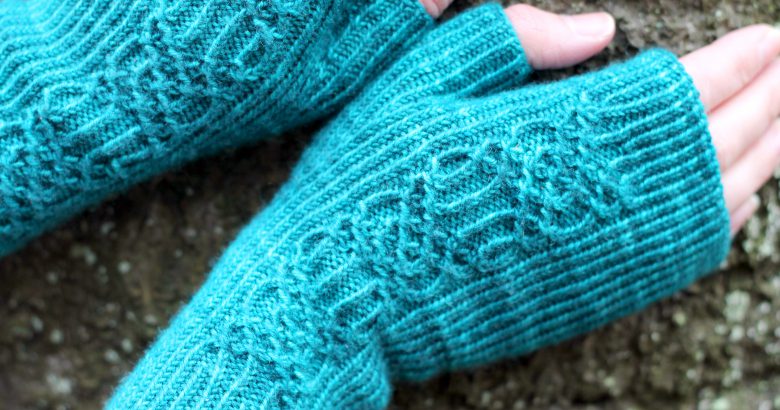 Twisted rib fingerless mitts with a smocked faux cable trellis patter asymmetrically on the back of the hand
