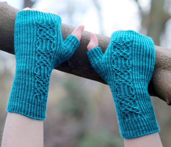Twisted rib fingerless mitts with a smocked faux cable trellis patter asymmetrically on the back of the hand