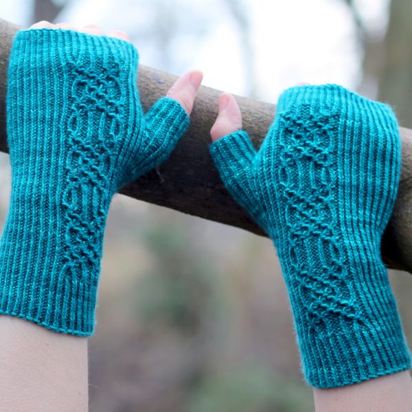 Twisted rib fingerless mitts with a smocked faux cable trellis patter asymmetrically on the back of the hand