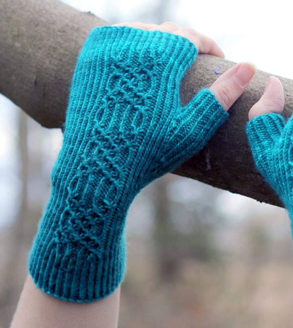 Twisted rib fingerless mitts with a smocked faux cable trellis patter asymmetrically on the back of the hand