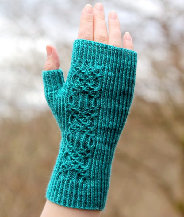 Twisted rib fingerless mitts with a smocked faux cable trellis patter asymmetrically on the back of the hand