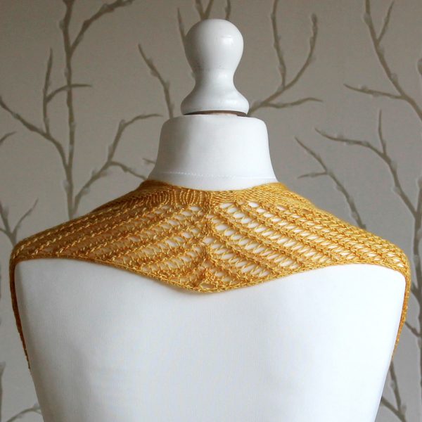 A yellow cowl with a ribbed body and wide lace border