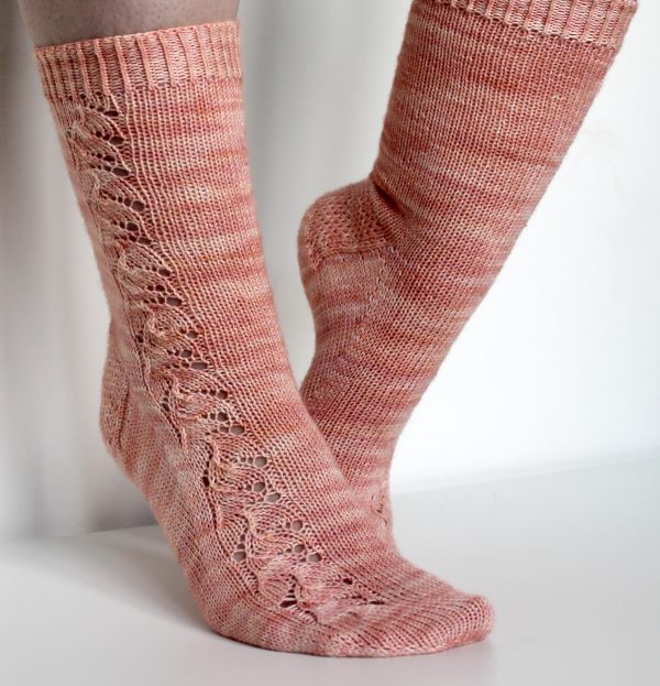 Pink socks with a floral pattern up the outside of the foot and leg