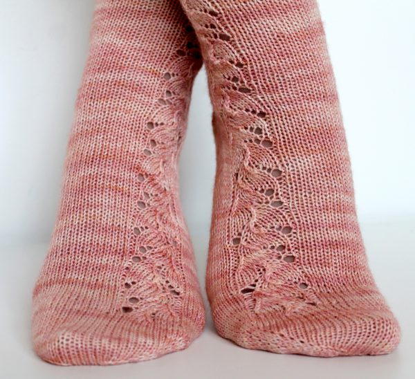 Pink socks with a floral pattern up the outside of the foot and leg