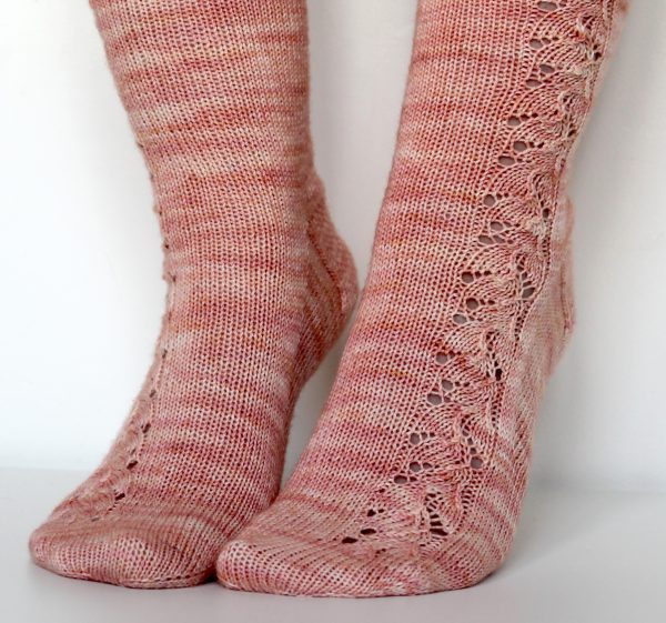 Pink socks with a floral pattern up the outside of the foot and leg