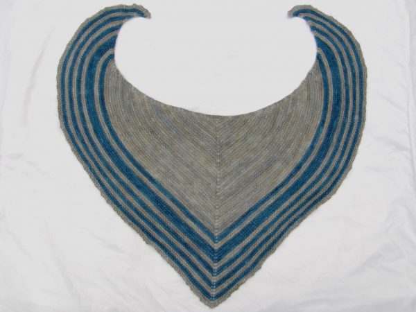 A triangular shaped shawl with a smooth striped edge