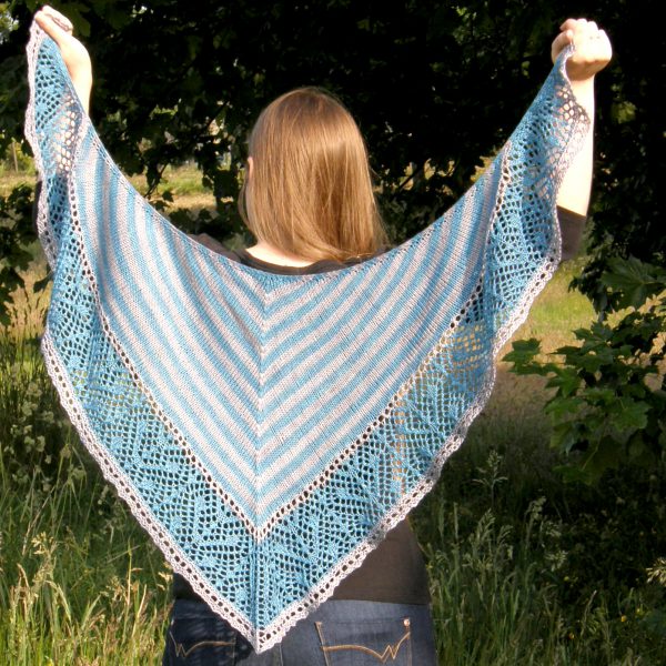 A triangular shawl with a striped stockinette body and a wide lace panel