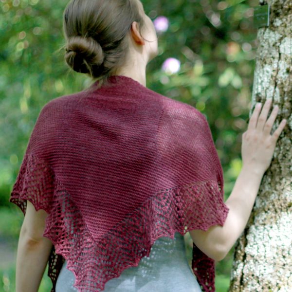 A triangular garter stitch shawl with a knitted on lace border