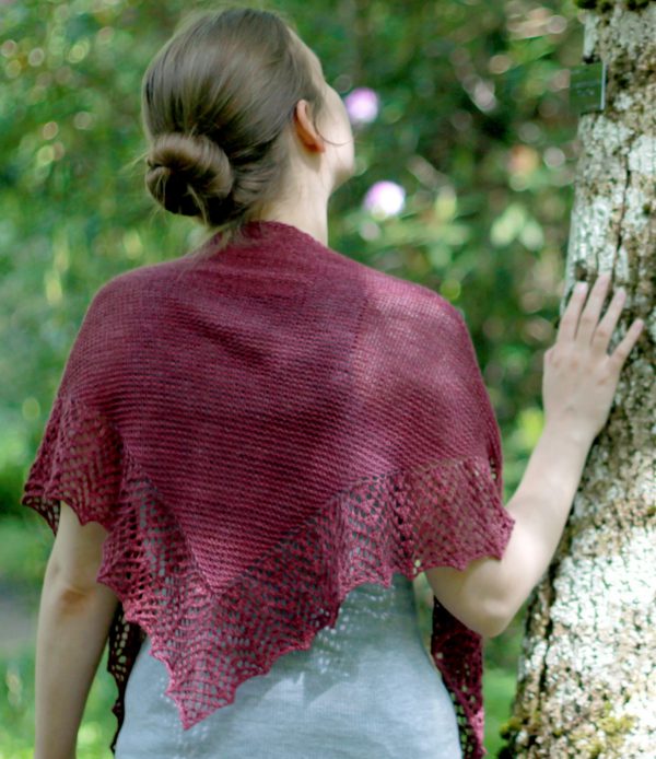 A triangular garter stitch shawl with a knitted on lace border