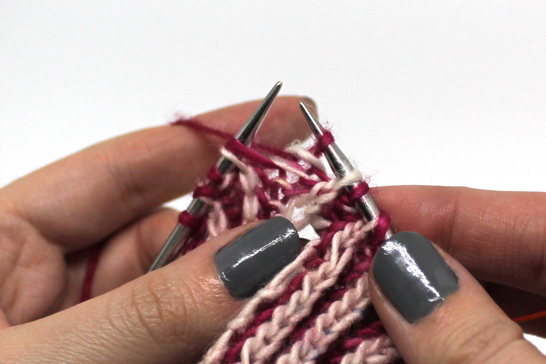 A brp stitch worked in pink yarn.