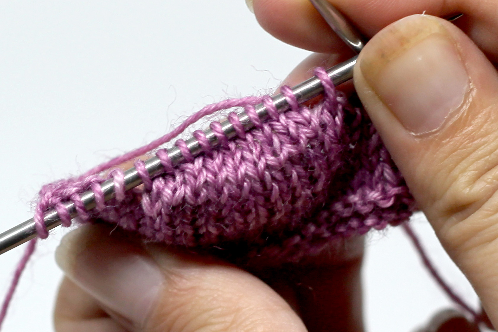 The finished short rows on the needle showing the slight shaping in the knitting.