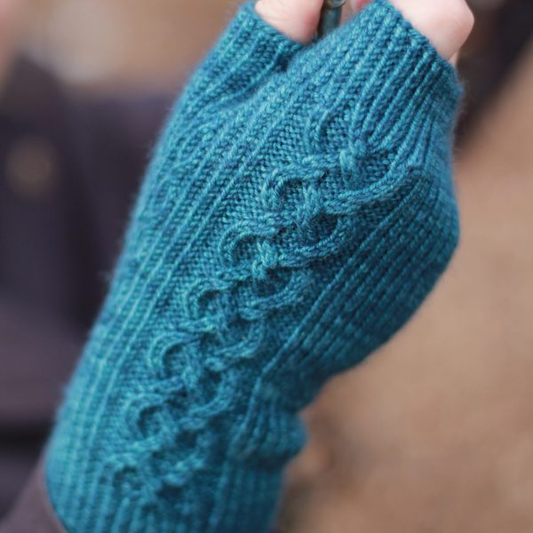 Twisted rib fingerless mitts with a large cable up the back of the hand and a narrow cable pattern that splits around the thumb