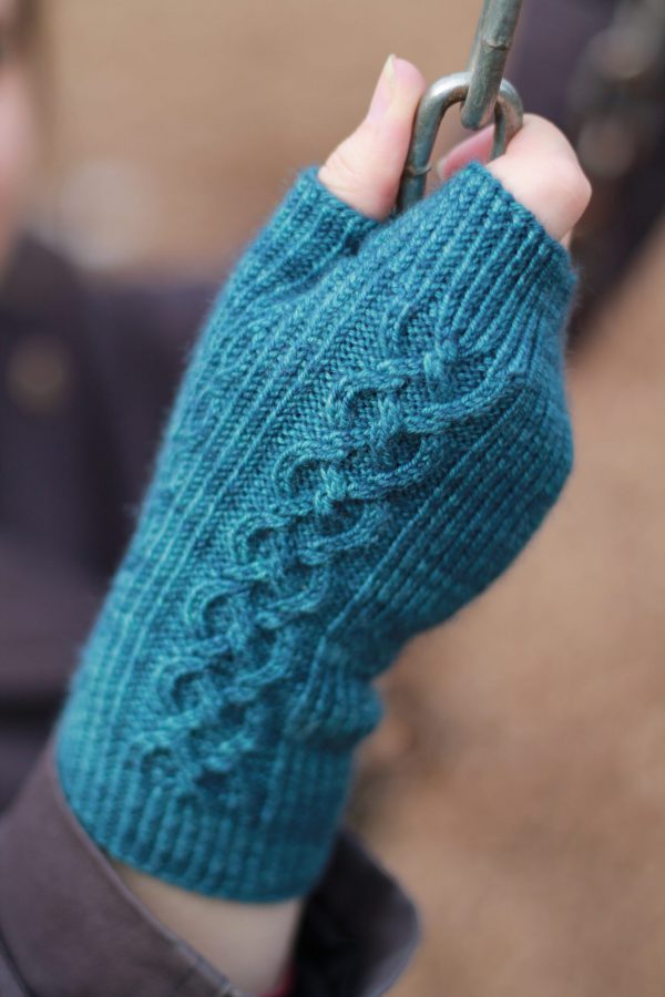 Twisted rib fingerless mitts with a large cable up the back of the hand and a narrow cable pattern that splits around the thumb