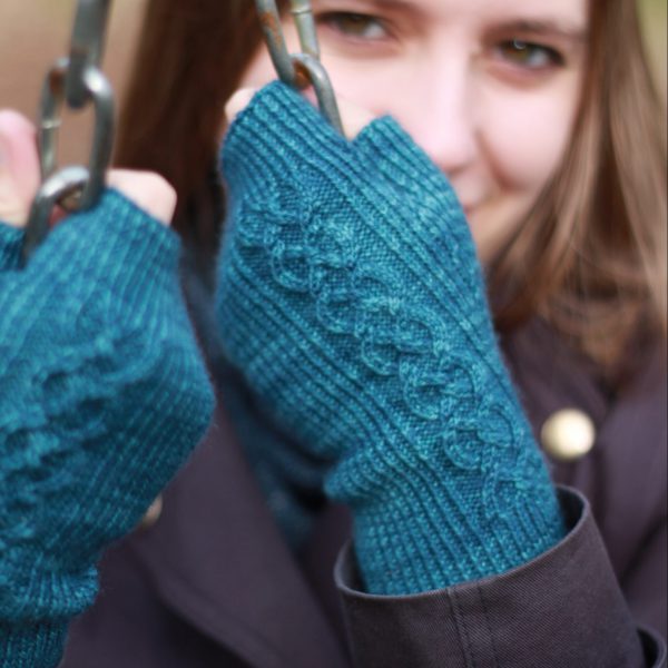 Twisted rib fingerless mitts with a large cable up the back of the hand and a narrow cable pattern that splits around the thumb