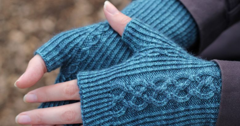 Twisted rib fingerless mitts with a large cable up the back of the hand and a narrow cable pattern that splits around the thumb