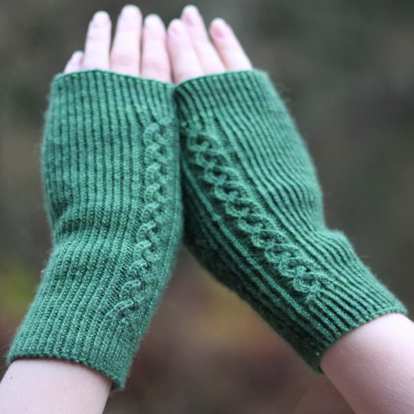 Twisted rib fingerless mitts with a large cable up the back of the hand and a narrow cable pattern that splits around the thumb