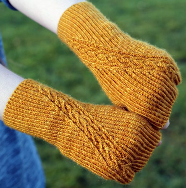 Twisted rib fingerless mitts with a narrow cable crossing the back of the hand from the inside of the wrist to the little finger. The little finger has a separate opening.