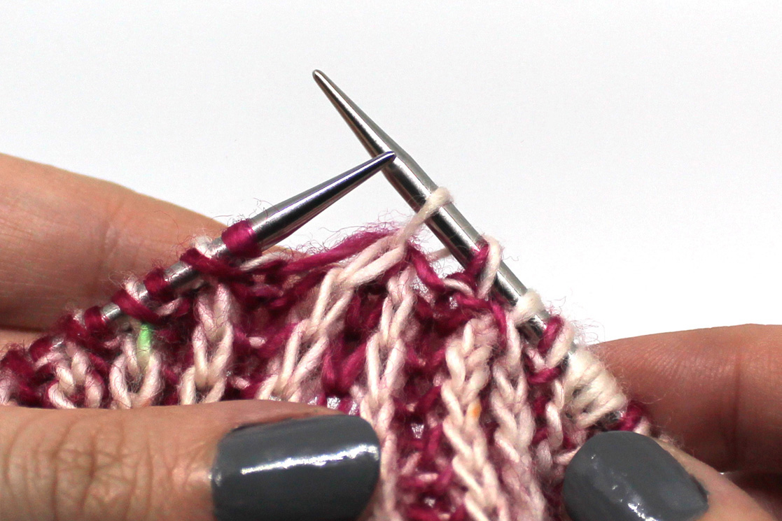 The completed stitch on the right hand needle