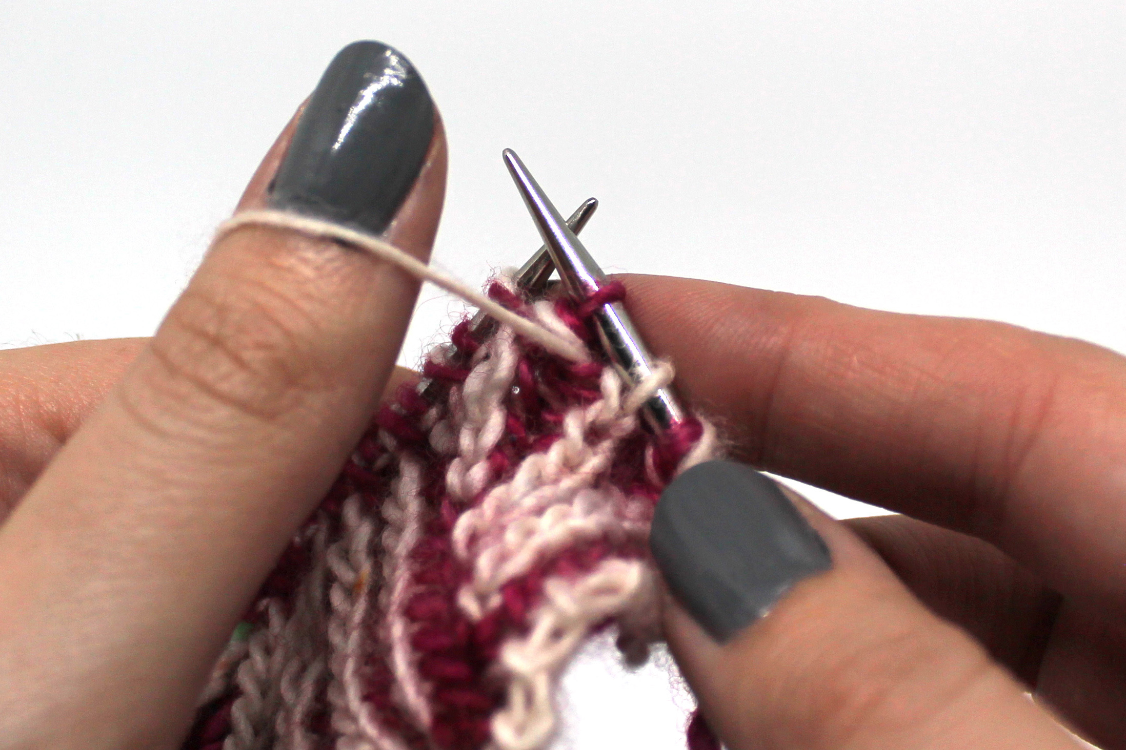 The first stitch on the left hand needle has been slipped to the right hand needle