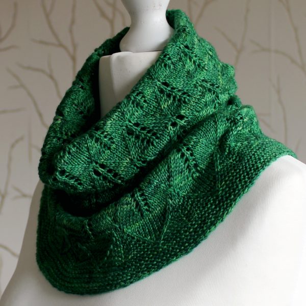 A green cowl with diamond shaped leaves and a wide lace border modelled on a mannequin