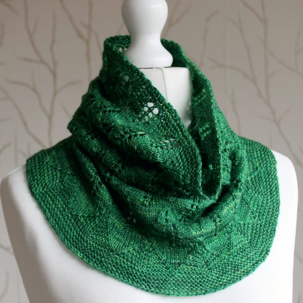 A green cowl with diamond shaped leaves and a wide lace border modelled on a mannequin