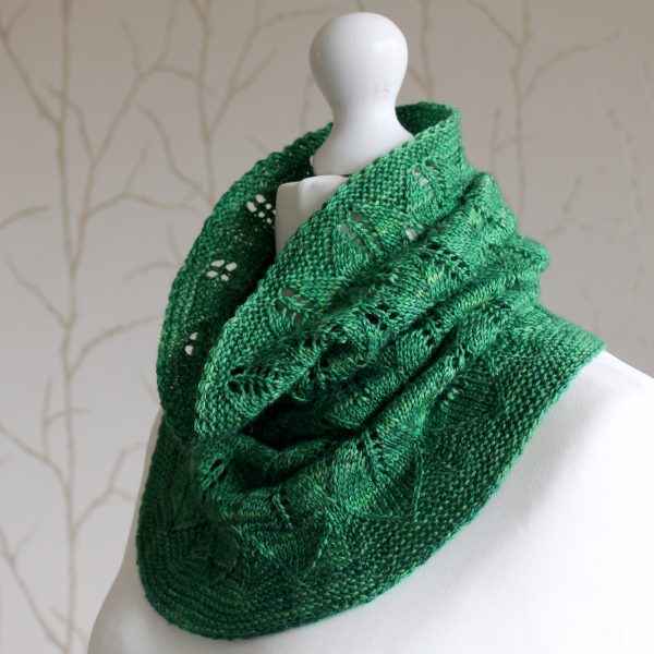 A green cowl with diamond shaped leaves and a wide lace border modelled on a mannequin