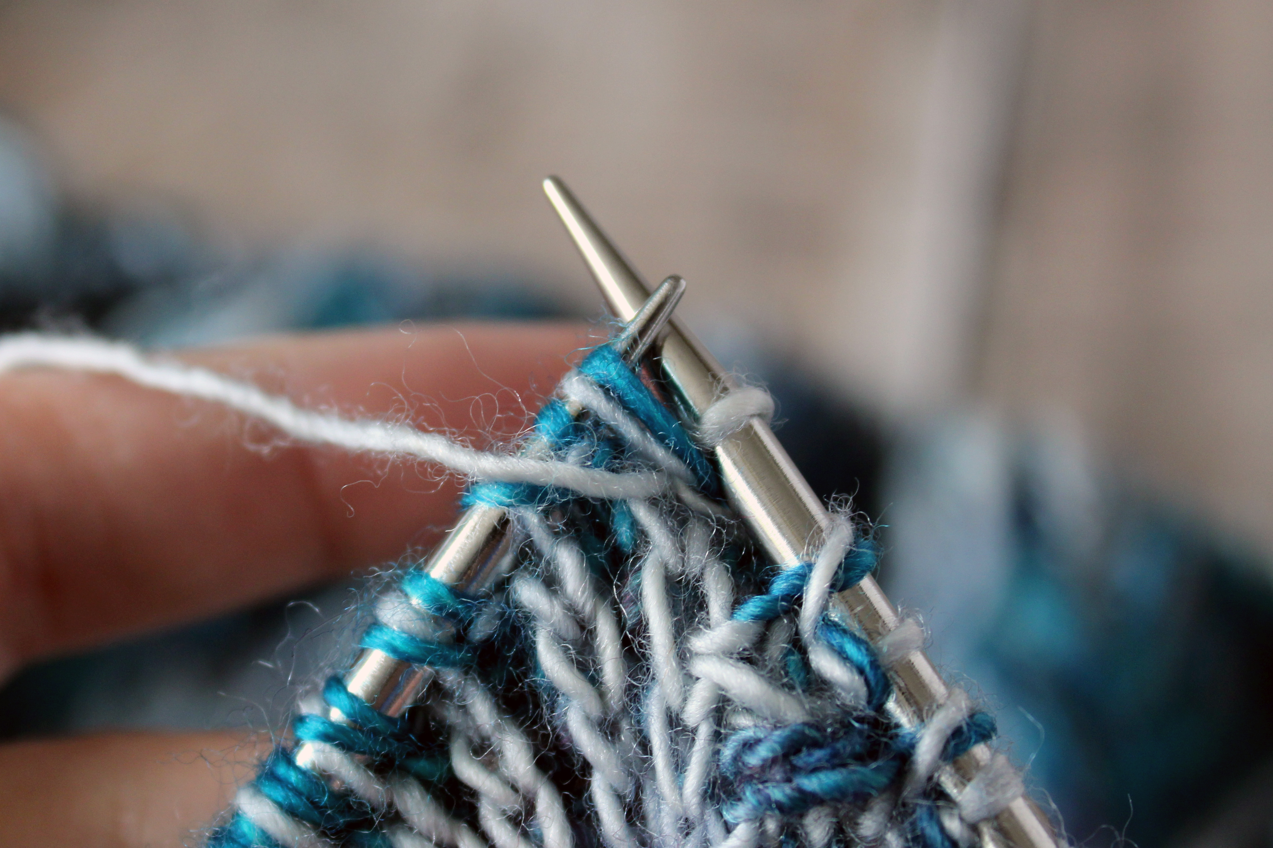 A brioche purl with the original stitch still on the left hand needle