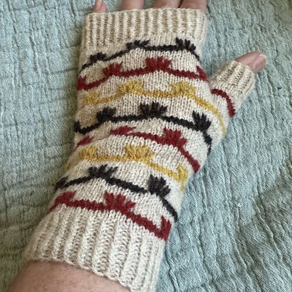 A fingerless mitt with coloured stripes and slipped stitches