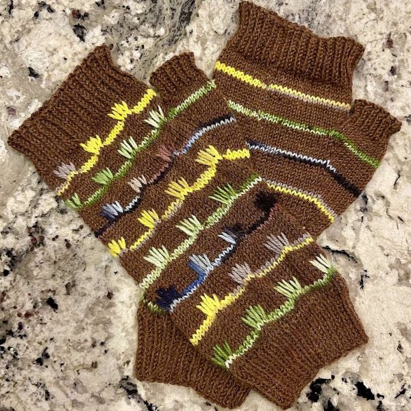 A pair of mitts with coloured stripes and slipped stitches