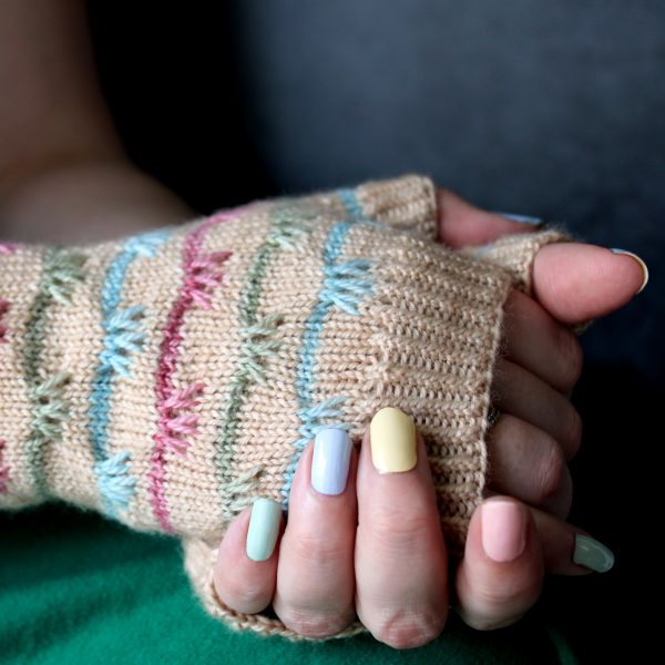 A pair of mitts with coloured stripes and slipped stitches on the back of the hand