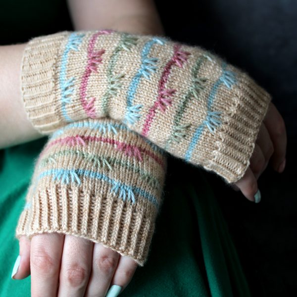 A pair of mitts with coloured stripes and slipped stitches on the back of the hand