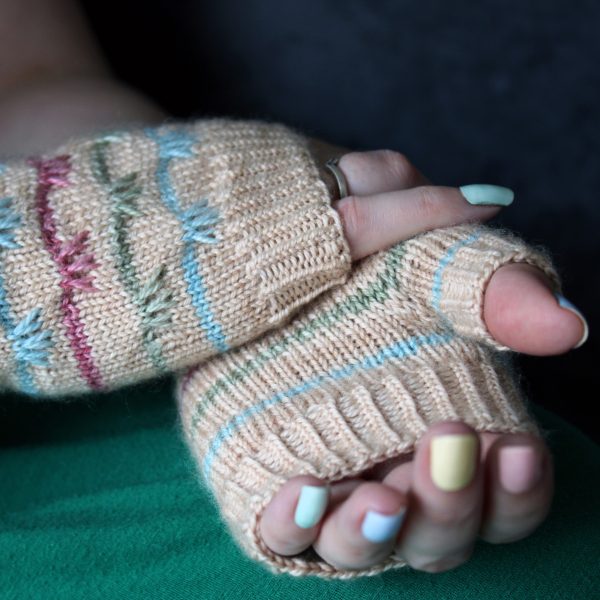 The palm and hand of a pair of mitts with coloured stripes and slipped stitches