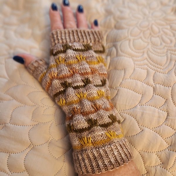 A fingerless mitt with coloured stripes and slipped stitches