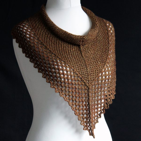 A cowlette knit in brown yarn with a textured slipped stitch pattern on the body, a wide lace border and a rippling bind-off