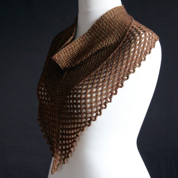 A cowlette knit in brown yarn with a textured slipped stitch pattern on the body, a wide lace border and a rippling bind-off